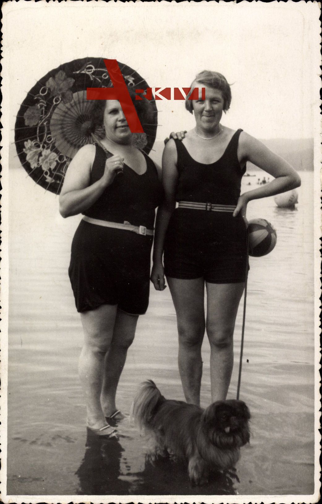 Zwei Frauen in Badekleidern am Strand, Sonnenschirm, Hund