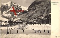 Grindelwald Kt. Bern, Eislaufbahn mit Ortschaft und Berglandschaft