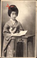 Japan, Japanerin in Kimono liest ein Buch, Steckfrisur